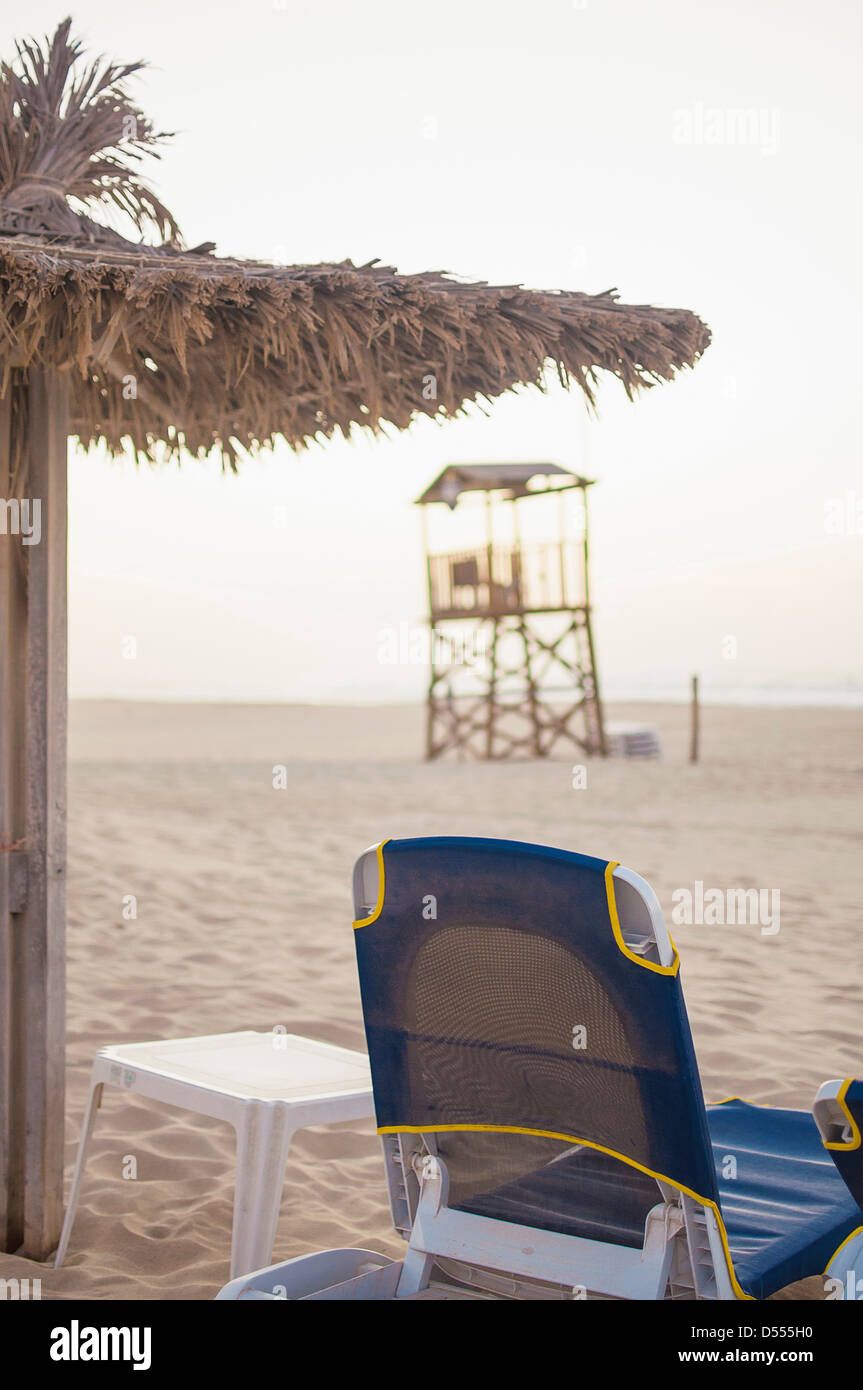 Lawn chair and umbrella on beach Stock Photo Alamy