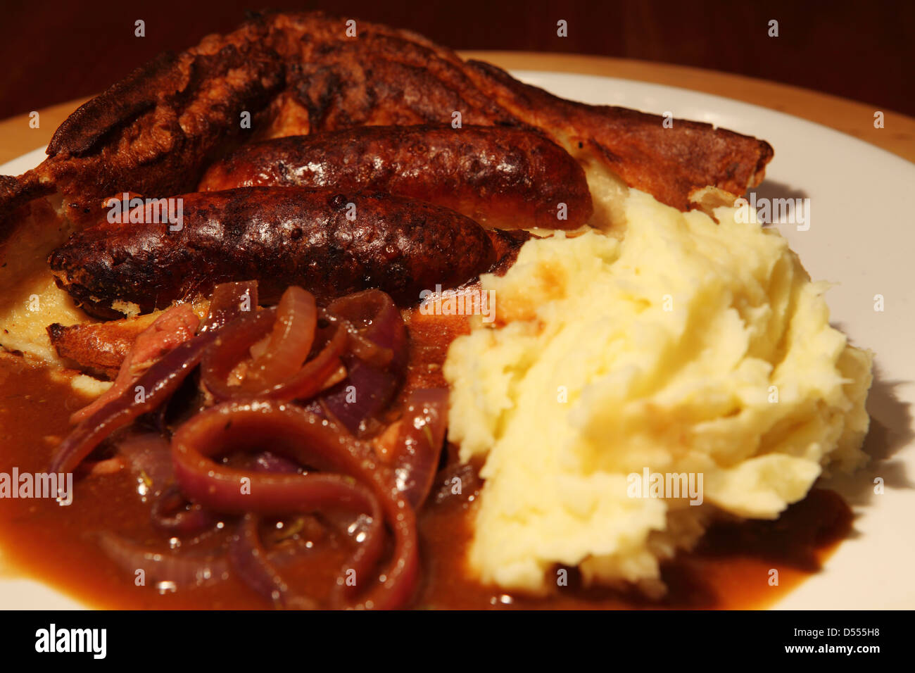 Toad in the Hole is served with onion gravy and mashed potatoes Stock