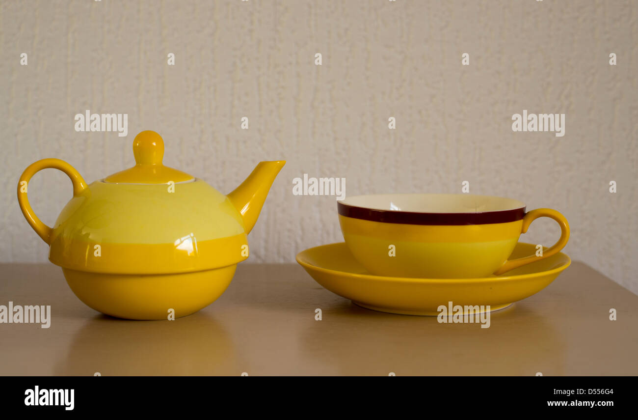 yellow teapot and cup on table Stock Photo Alamy