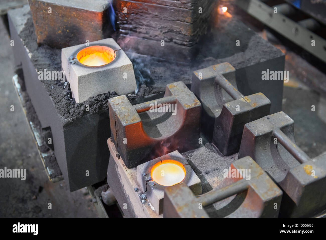 Molten metal in moulds in foundry Stock Photo