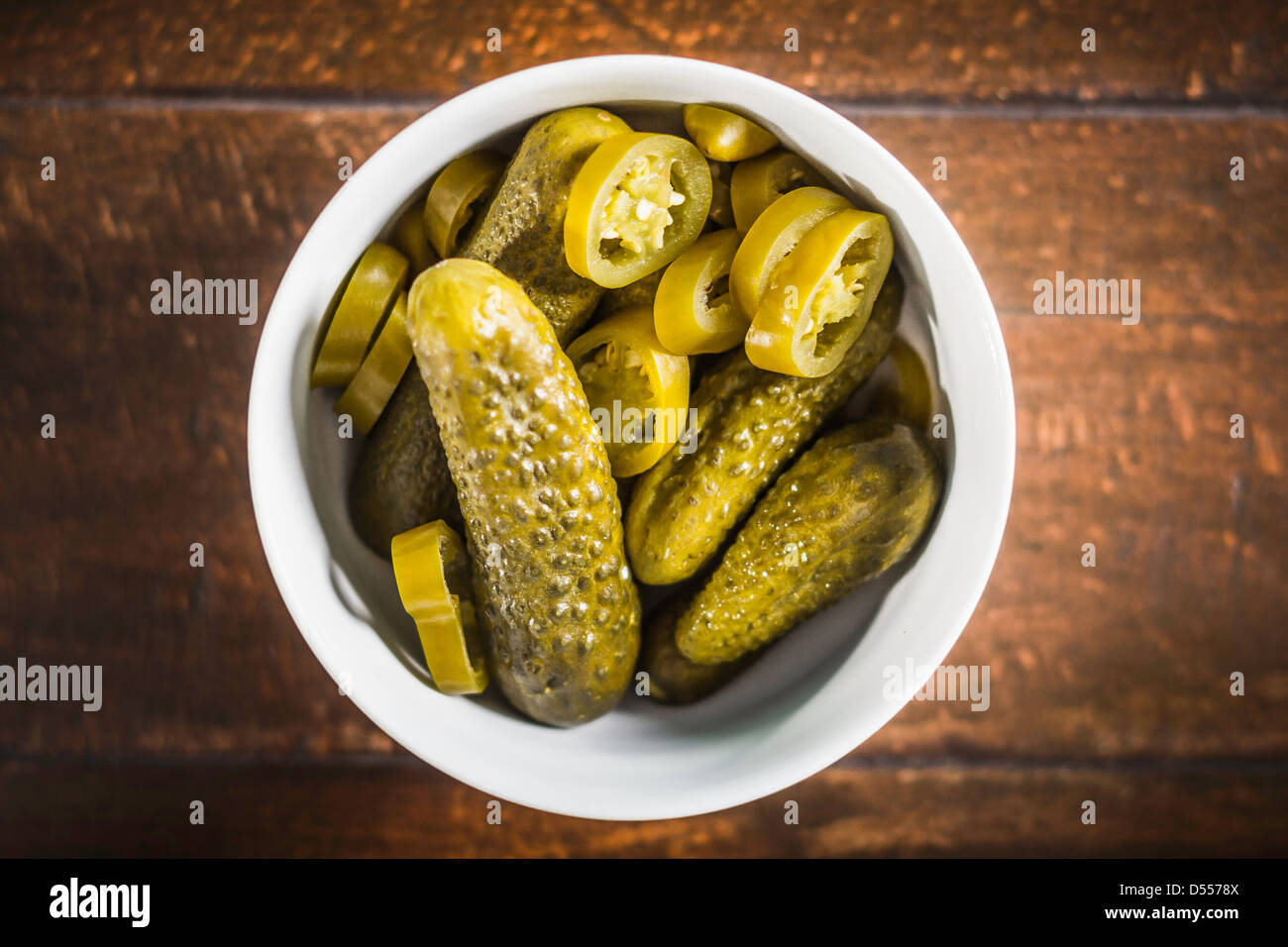 Bowl of pickles and chili pepper slices Stock Photo