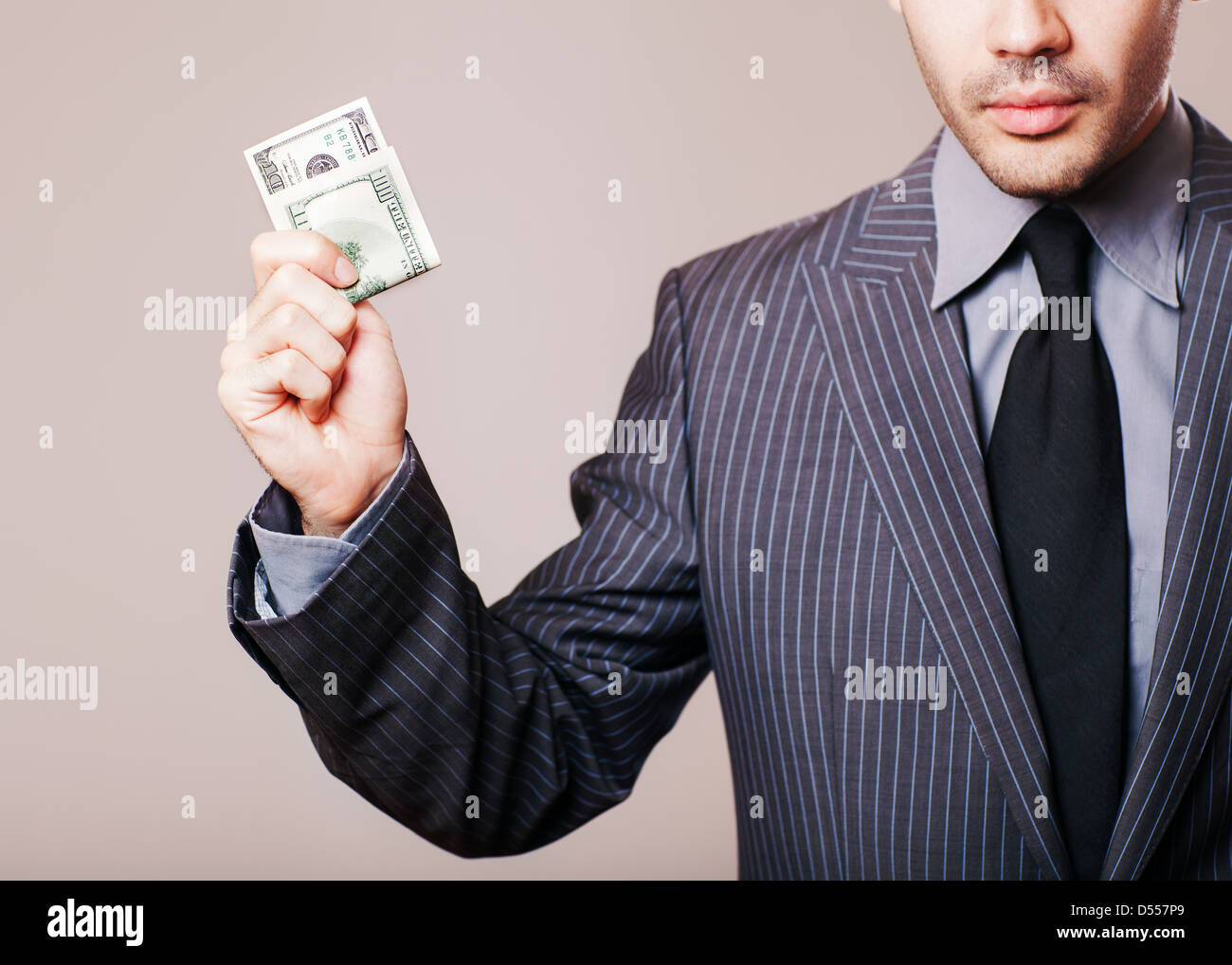 cheerful caucasian young businessman in gray suit holding money isolated on white background Stock Photo