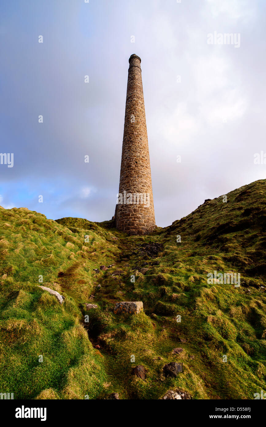 A lone chimney from abondoned tin mines reaches for the sky on Cornwall's rugged West coast, near Land's End.  Stock Photo