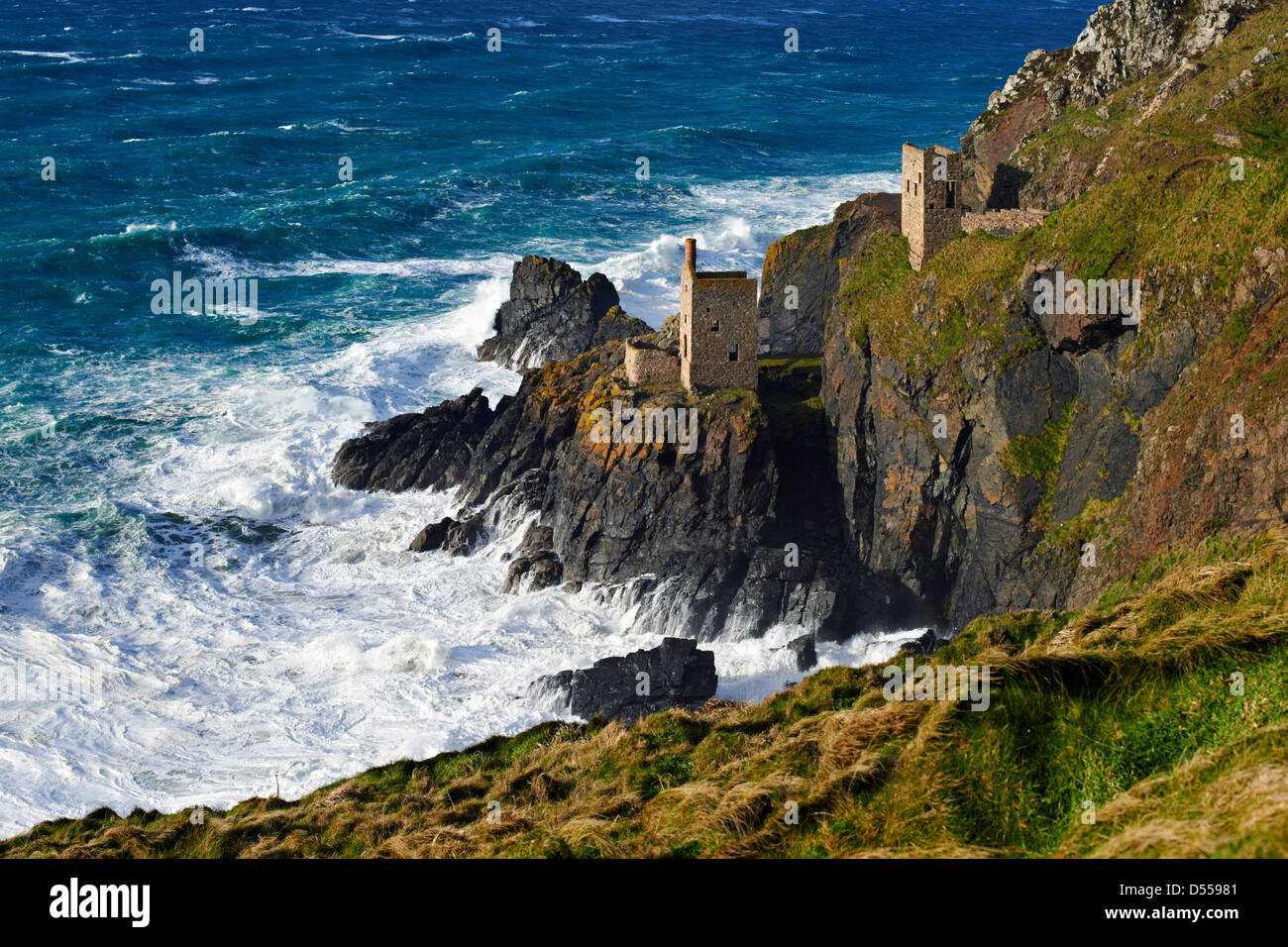 An abondoned tin mine perched on a cliff face near Botallack, Cornwall Stock Photo