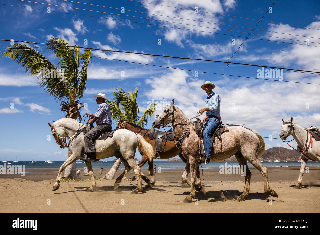 Riding horses on the beach during the Tope de Caballos at Coco Beach, Playas del Coco, Guanacaste, Costa Rica. Stock Photo