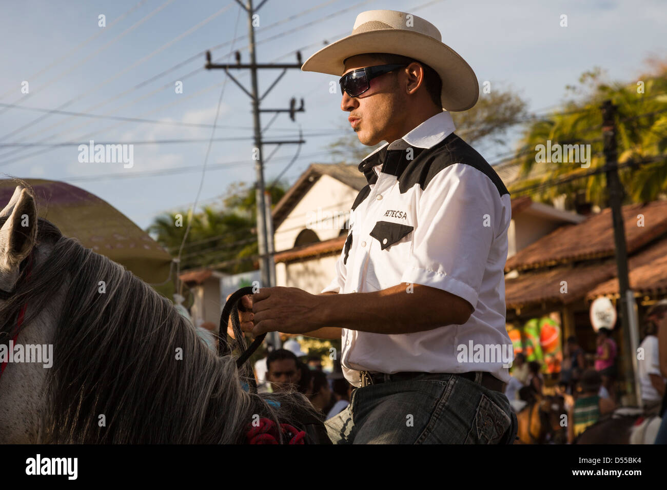 Costa Rican cowboys riding through town during the Tope de Caballos at Coco Beach, Playas del Coco, Guanacaste, Costa Rica. Stock Photo