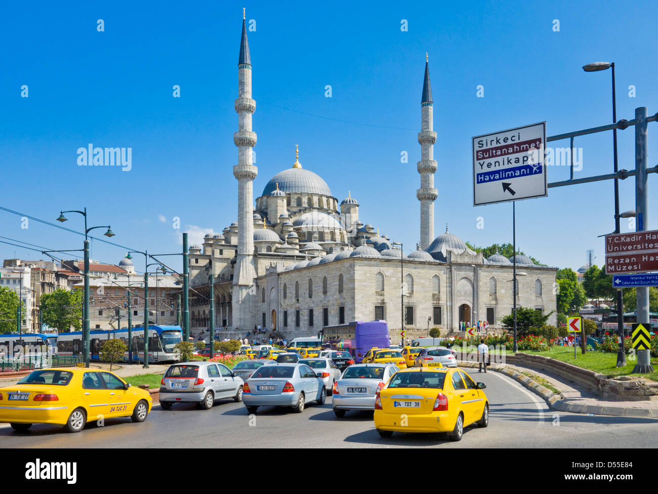Busy traffic, yellow taxis and trams, in front of the Yeni Cami (New Mosque), Eminonu, Istanbul, Turkey Stock Photo