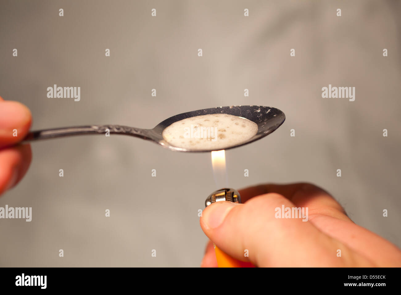Cooking drugs in a spoon with a lighter Stock Photo