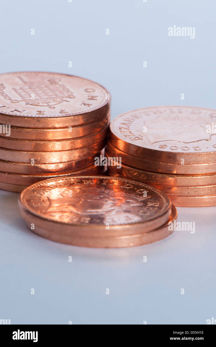 Close-up of new shiny coppers or pennies (British unit of currency 1p coins) in 3 small piles, grand total of money is 14 pence - England, GB, UK. Stock Photo