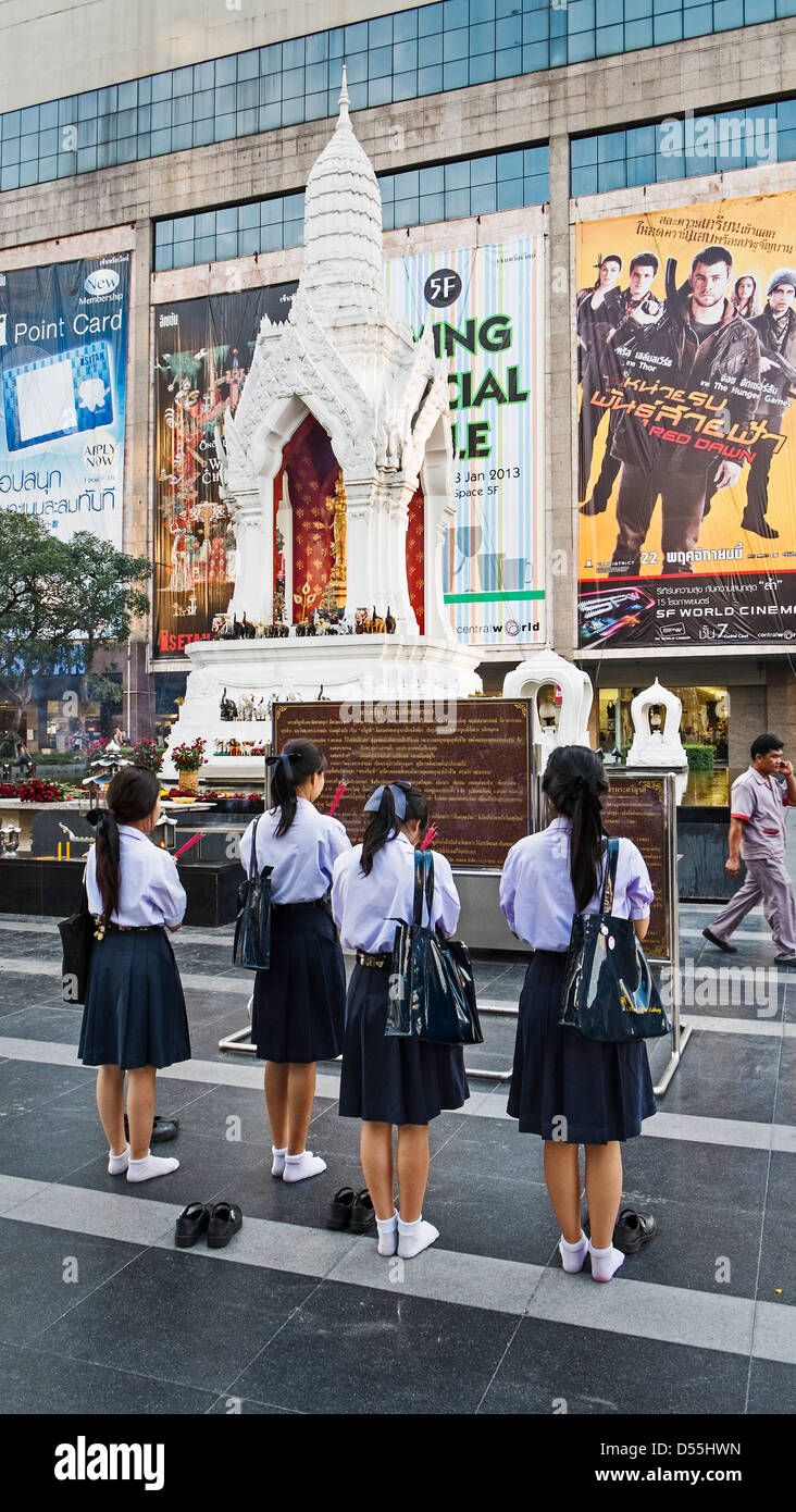 Schoolgirls at Ganesha-shrine in front of CentralWorld - shopping mall in Bangkok, Thailand, Asia Stock Photo