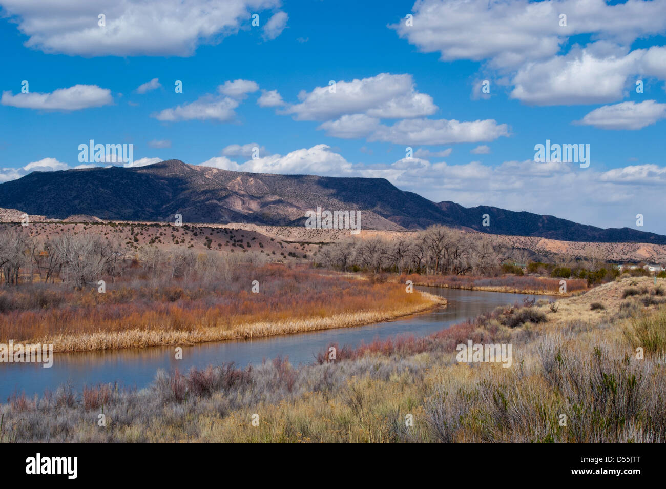 The Chama River meanders through the Piedra Lumbra basin, reflecting the colors of the winter landscape. Stock Photo