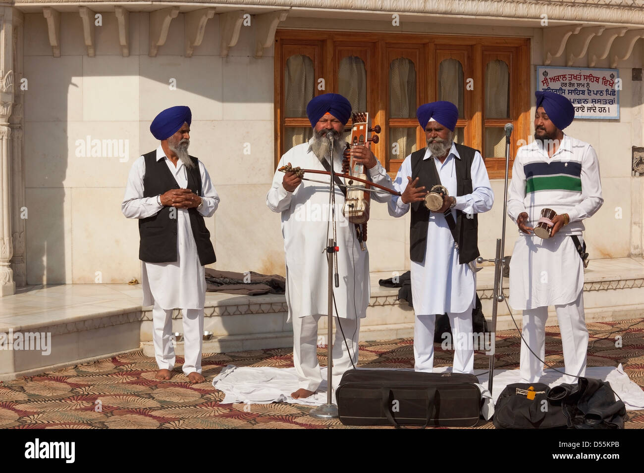 Four male musicians and story tellers with traditional Punjabi instruments at the Golden Temple