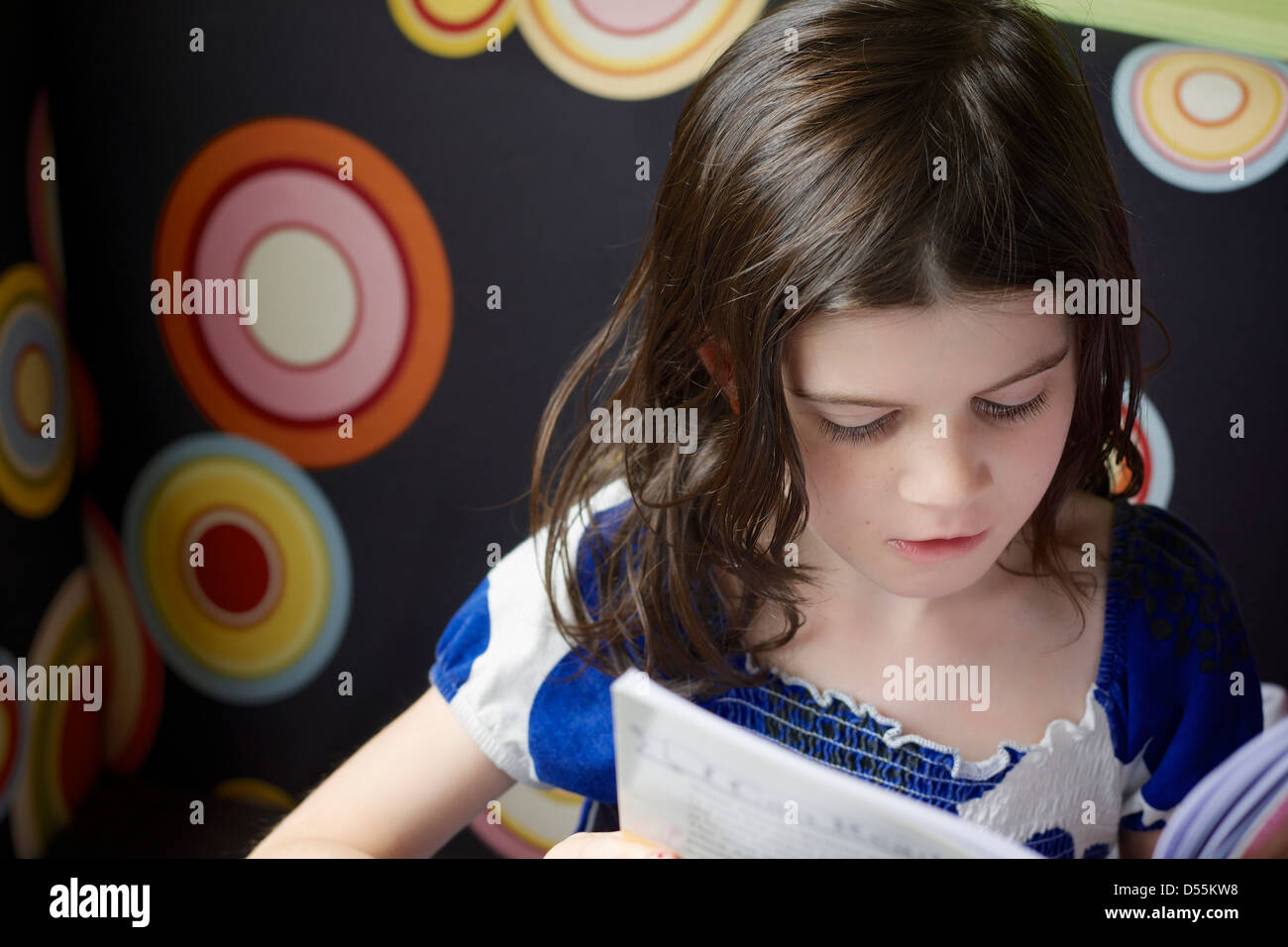 Six year old girl reading a book Stock Photo Alamy