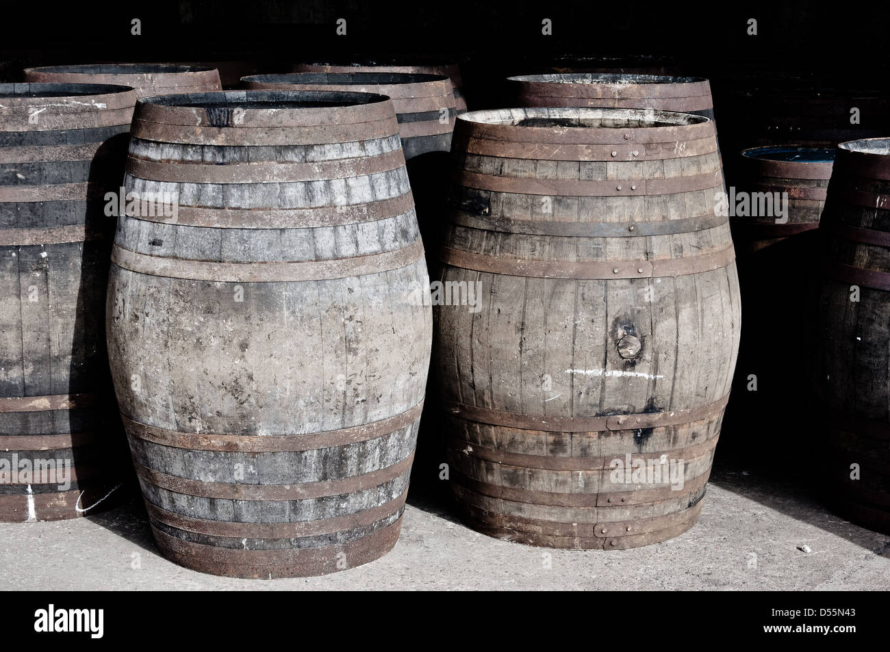 Whisky barrels stored in the Ben Nevis distillery warehouse lined up