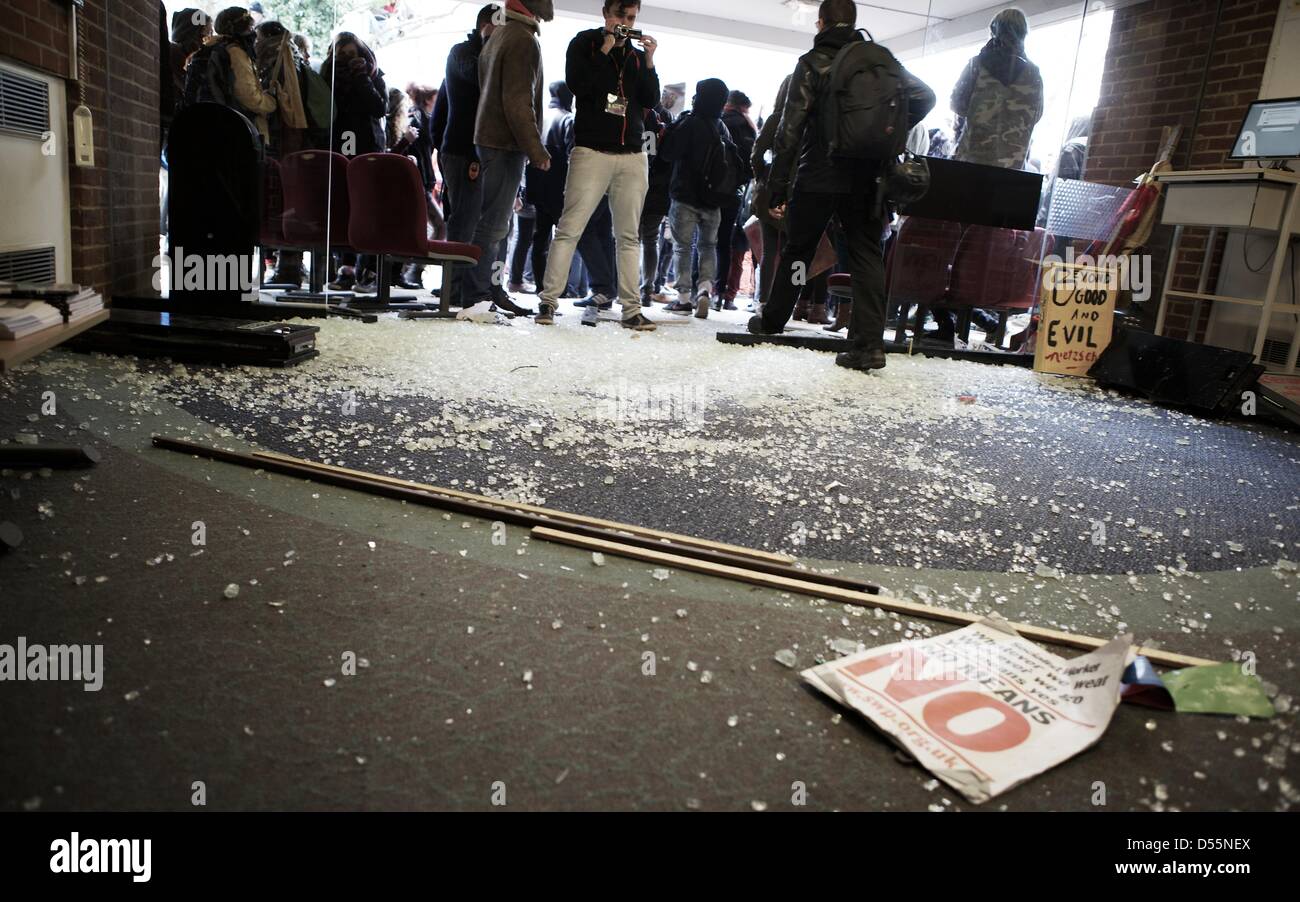 Brighton, Sussex, UK. 25 March 2013. A glass door lies in ruins after protesters smashed it with improvised battering rams, allowing them access to an management building at Sussex University. protesters were angry over the planned privatisation of a number of campus services which organisers say would result in job losses. Brief scuffles broke out during the day between police and protesters and the 'occupation', which has been running for over a month, continues. Credit: George Henton/Alamy Live News Stock Photo