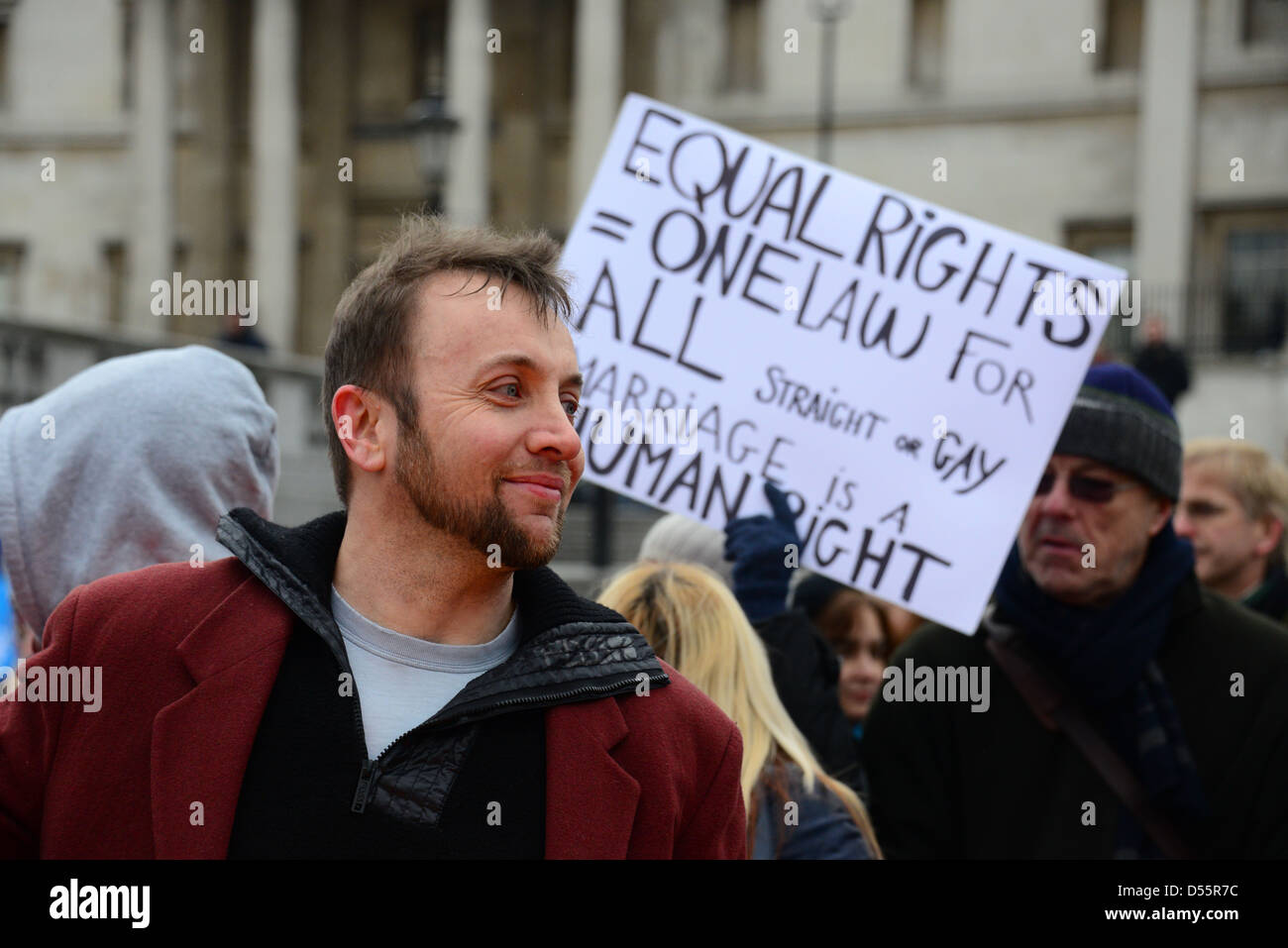 A protester holding a placard written 'Equal Rights = One Law for all, Straight or Gay. Marriage is a human right', in Trafalgar Stock Photo