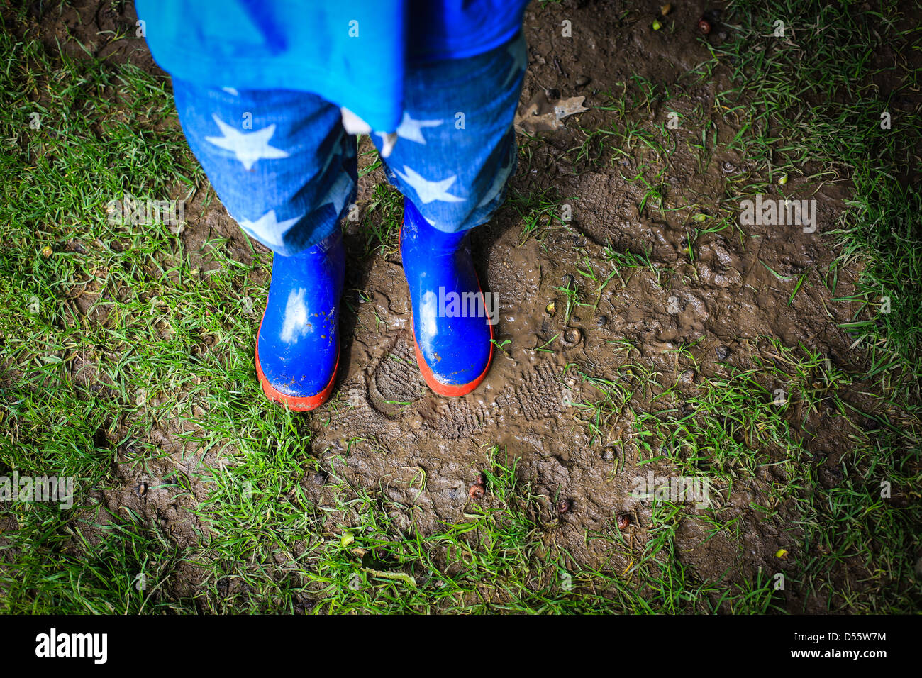 Child Wearing Blue Welly Boots Stock Photo