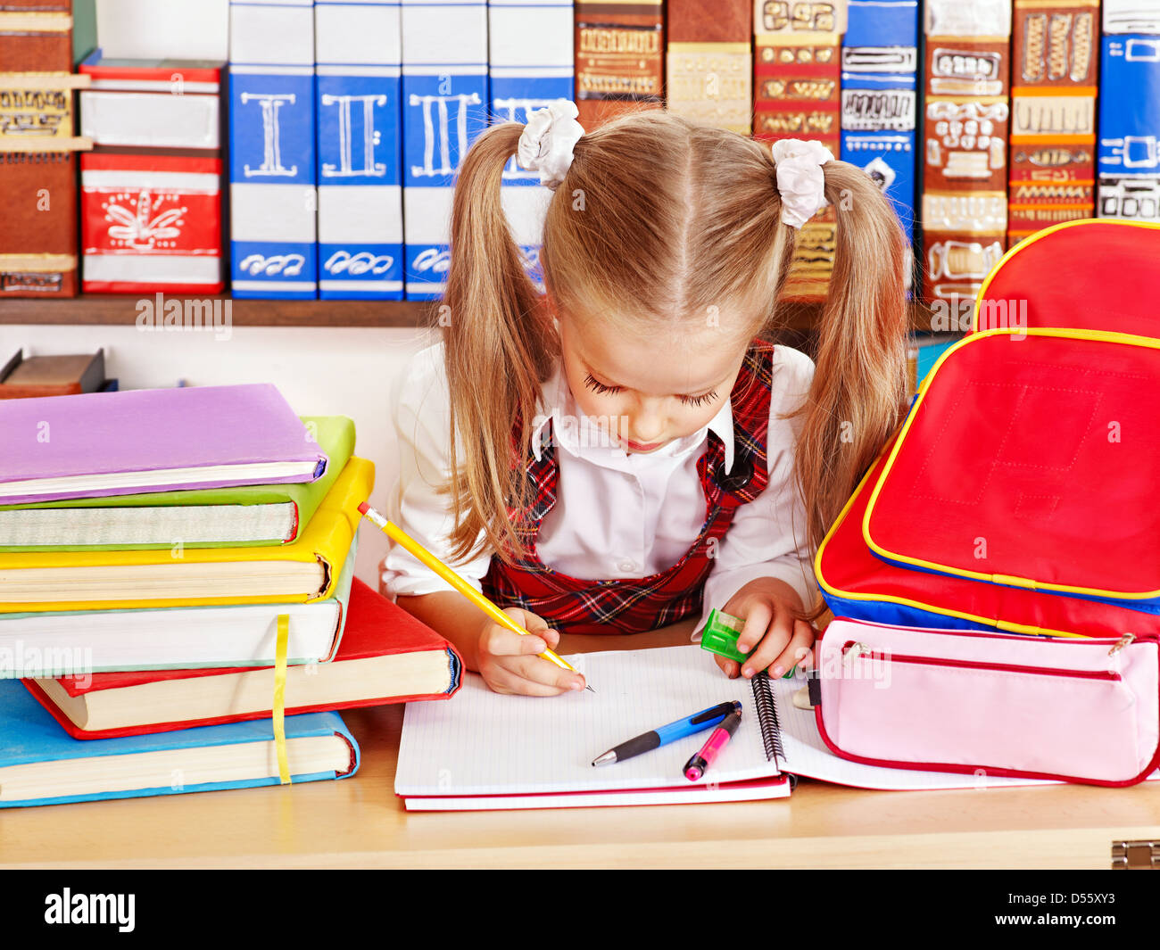 Child with backpack in classroom Stock Photo Alamy