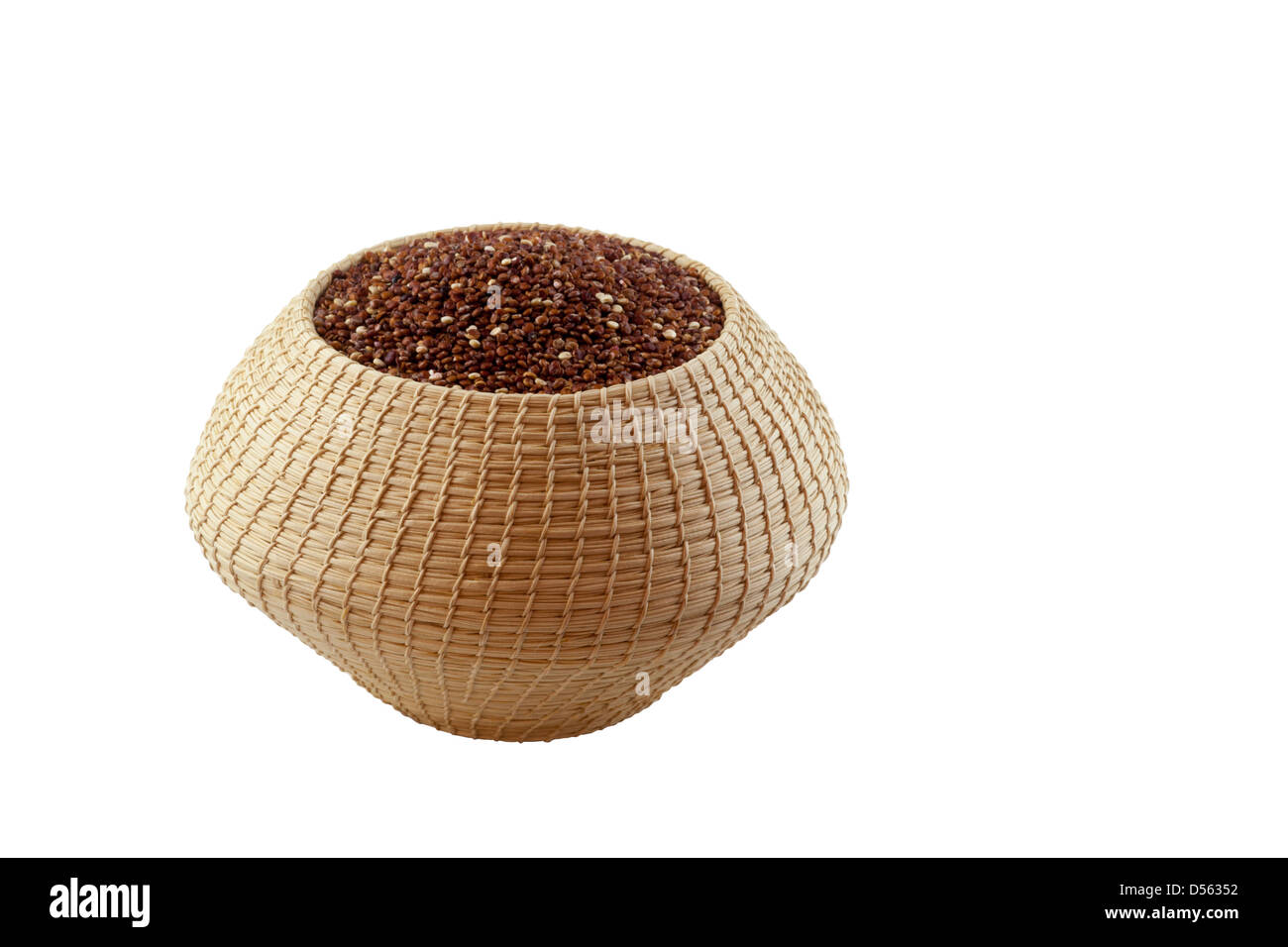 Organic red Quinoa (Chenopodium quinoa) in a Mayan basket made in Lubaantun, Belize, on a white background Stock Photo
