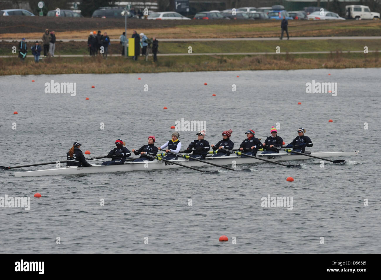 Eton Dorney, UK. 24th March 2013. Wearing colourful woolly hats and winter clothes against the biting cold, the Oxford crew begin to warm up shortly before The Newton Women's University Boat Race on Dorney Lake, Eton. Left to right, crew names are: Cox: Katie Apfelbaum, Stroke: Maxie Scheske, Seat 7: Anastasia Chitty, Seat 6: Harriet Keane, Seat 5: Amy Varney, Seat 4: Jo Lee, Seat 3: Mary Foord-Weston, Seat 2: Alice Carrington-Windo, Bow: Marianne Novak. Credit: Michael Preston / Alamy Live News Stock Photo