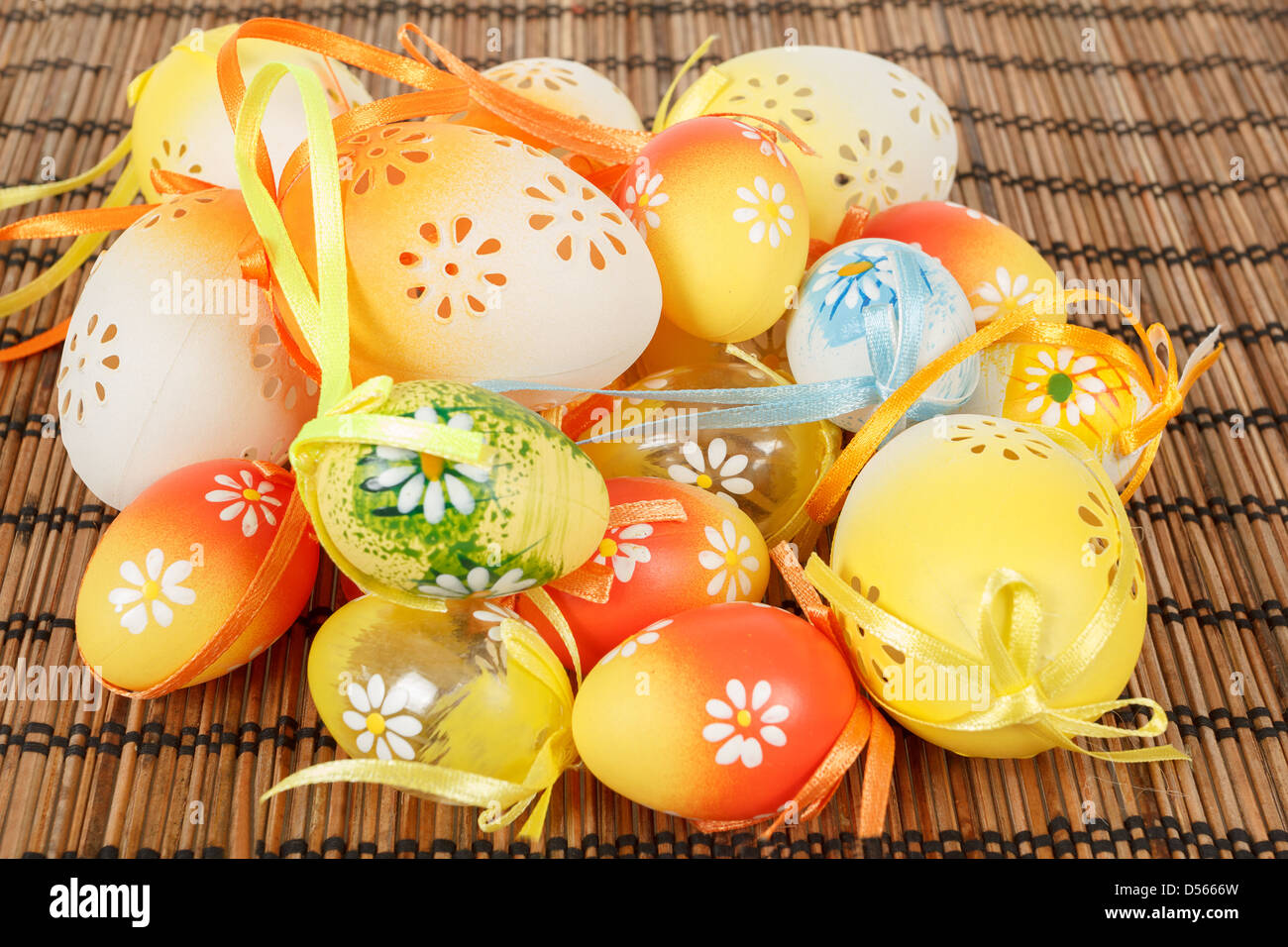Bright color easter eggs with bows on wooden desk Stock Photo - Alamy
