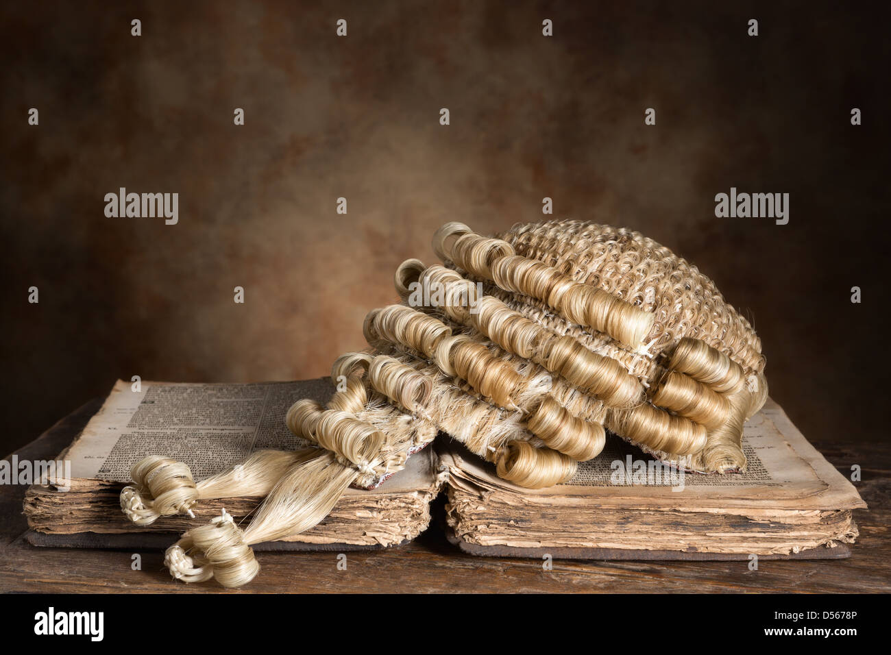 Genuine horsehair barrister's wig on an antique book (300 years old) Stock Photo