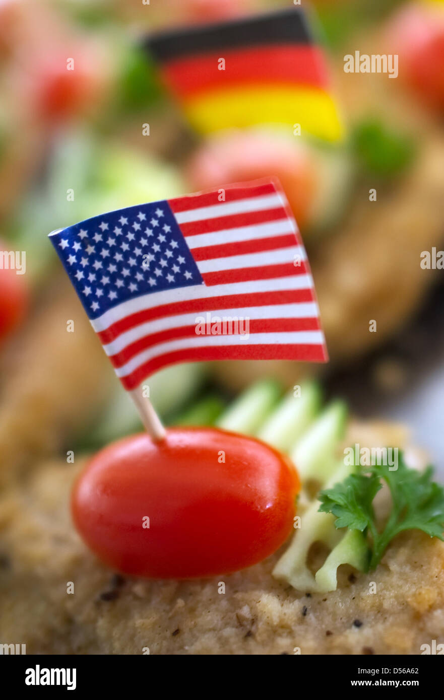 German and American flags stick in fried beef in Muehlberg, Germany, 1 November 2010. Photo: Arno Burgi Stock Photo