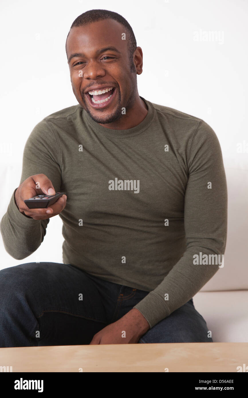 Black man using remote hi-res stock photography and images - Alamy