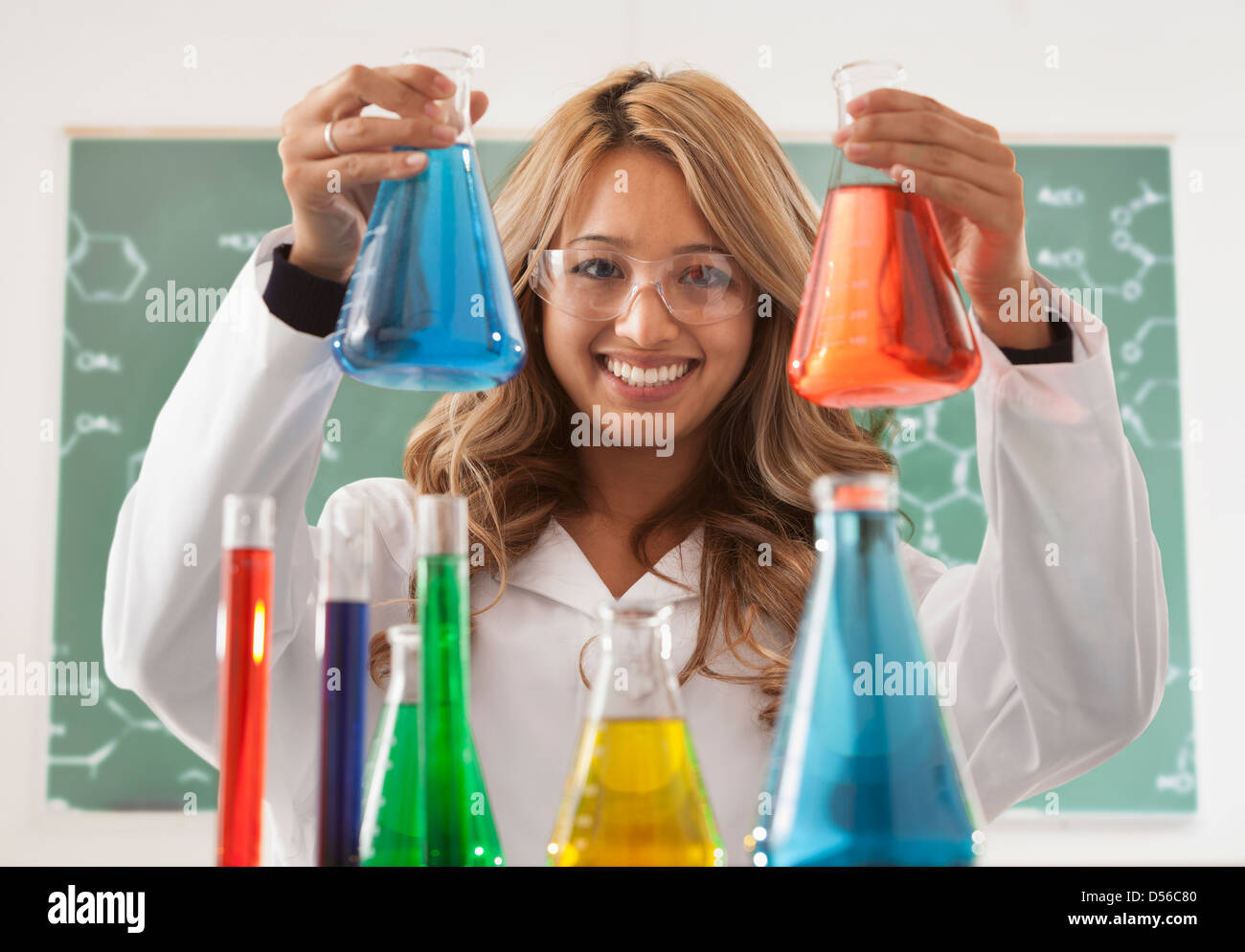 Mixed race student working in chemistry lab Stock Photo