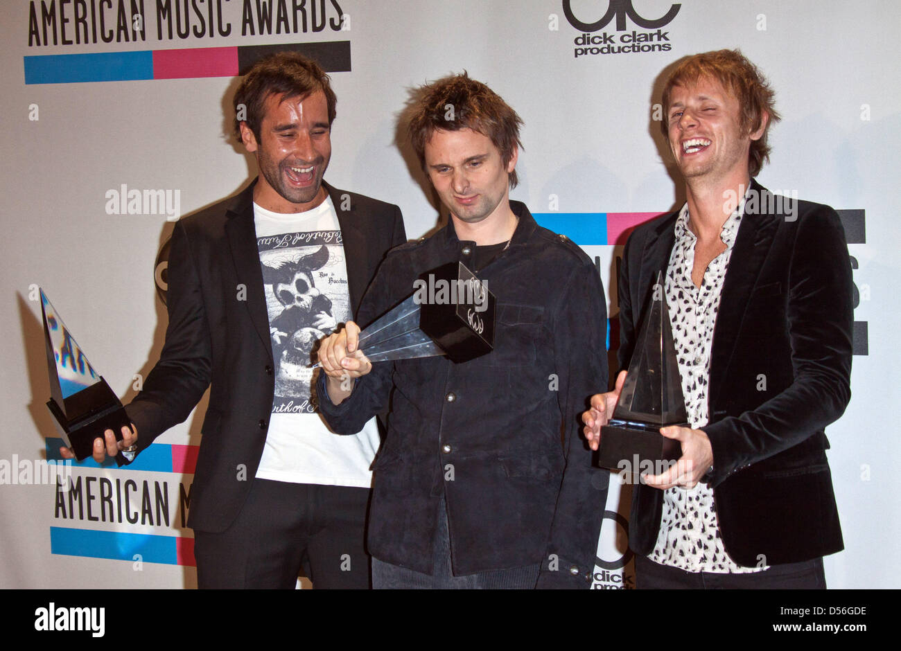 British rock band Muse with (L-R) Christopher Wolstenholme, Matthew Bellamy and Dominic Howard show their award for Favorite Alternative Rock Music Artist at the 38th Annual American Music Awards in Los Angeles, California, USA, 21 November 2010. Photo: Hubert Boesl Stock Photo