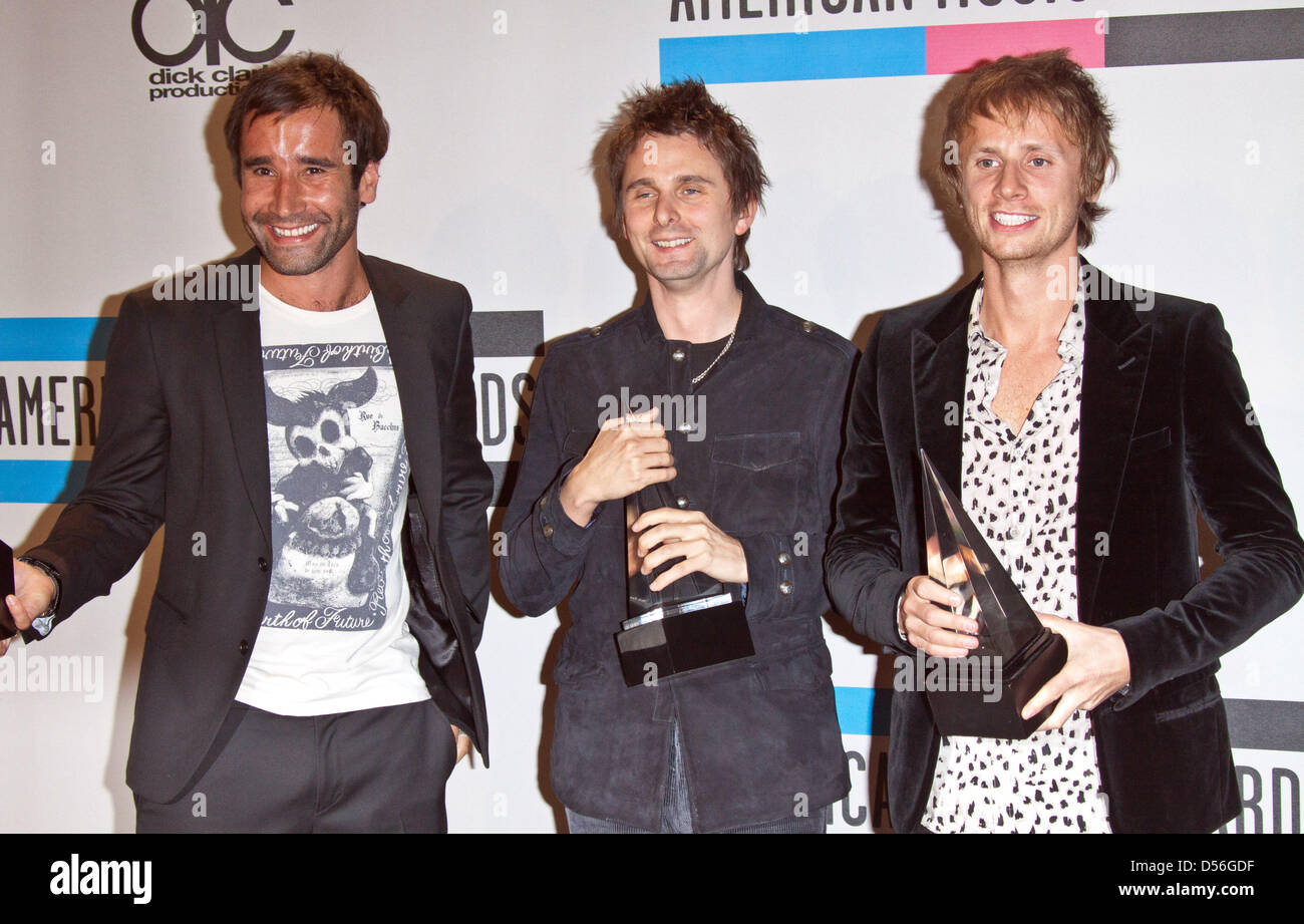 British rock band Muse with (L-R) Christopher Wolstenholme, Matthew Bellamy and Dominic Howard show their award for Favorite Alternative Rock Music Artist at the 38th Annual American Music Awards in Los Angeles, California, USA, 21 November 2010. Photo: Hubert Boesl Stock Photo