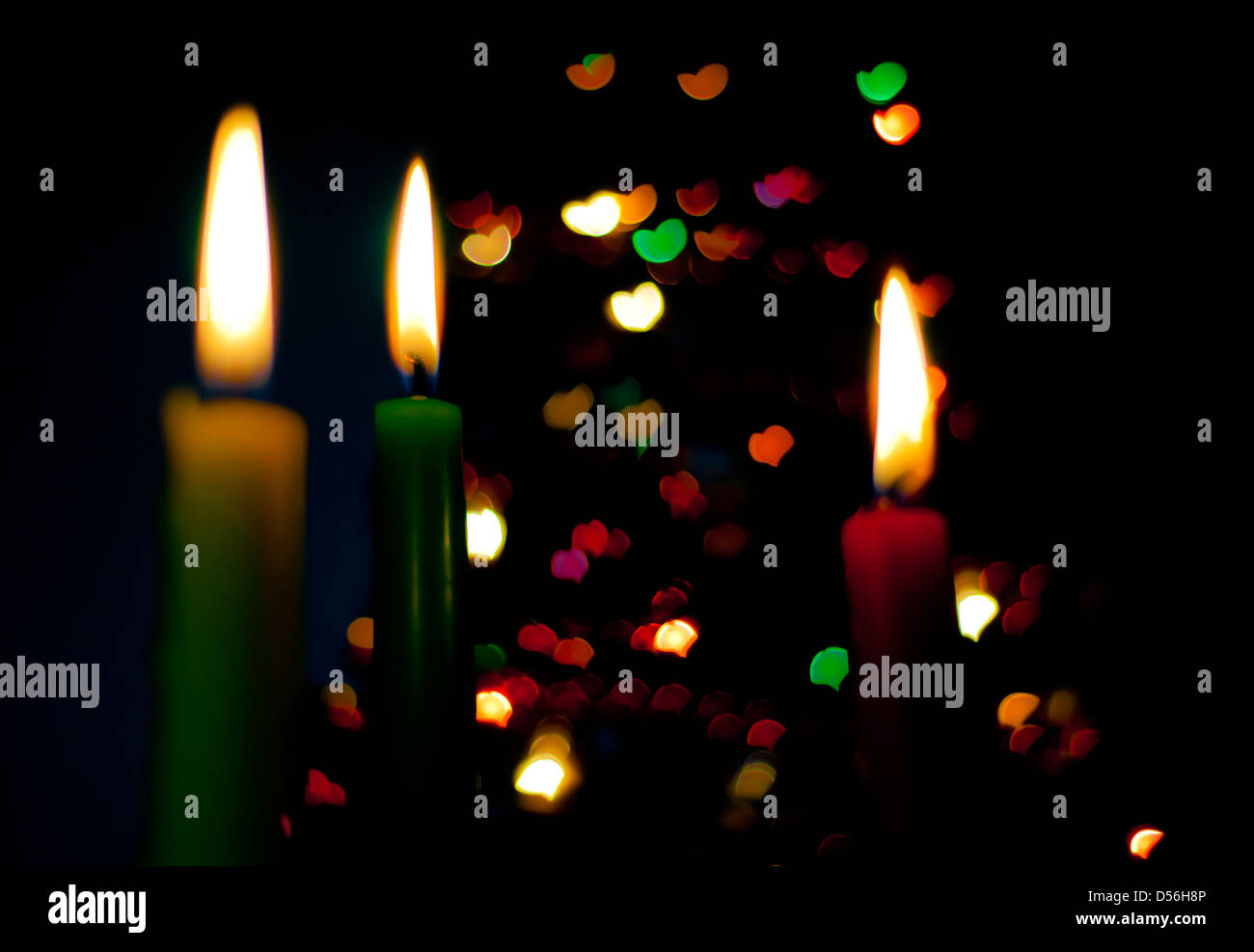 three candles on the black background with hearts Stock Photo - Alamy