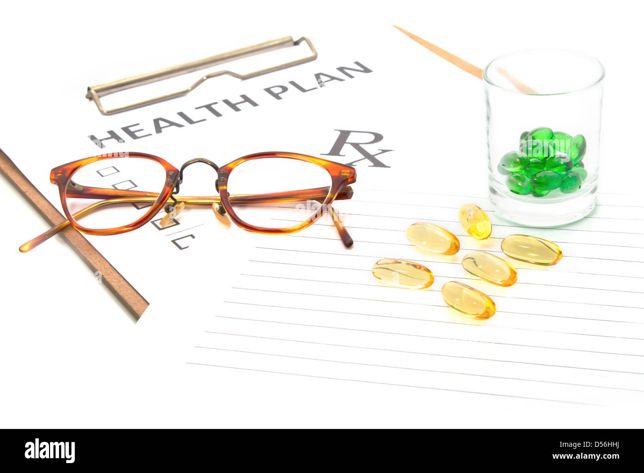 Glasses and pill capsules resting on health plan notes or patient