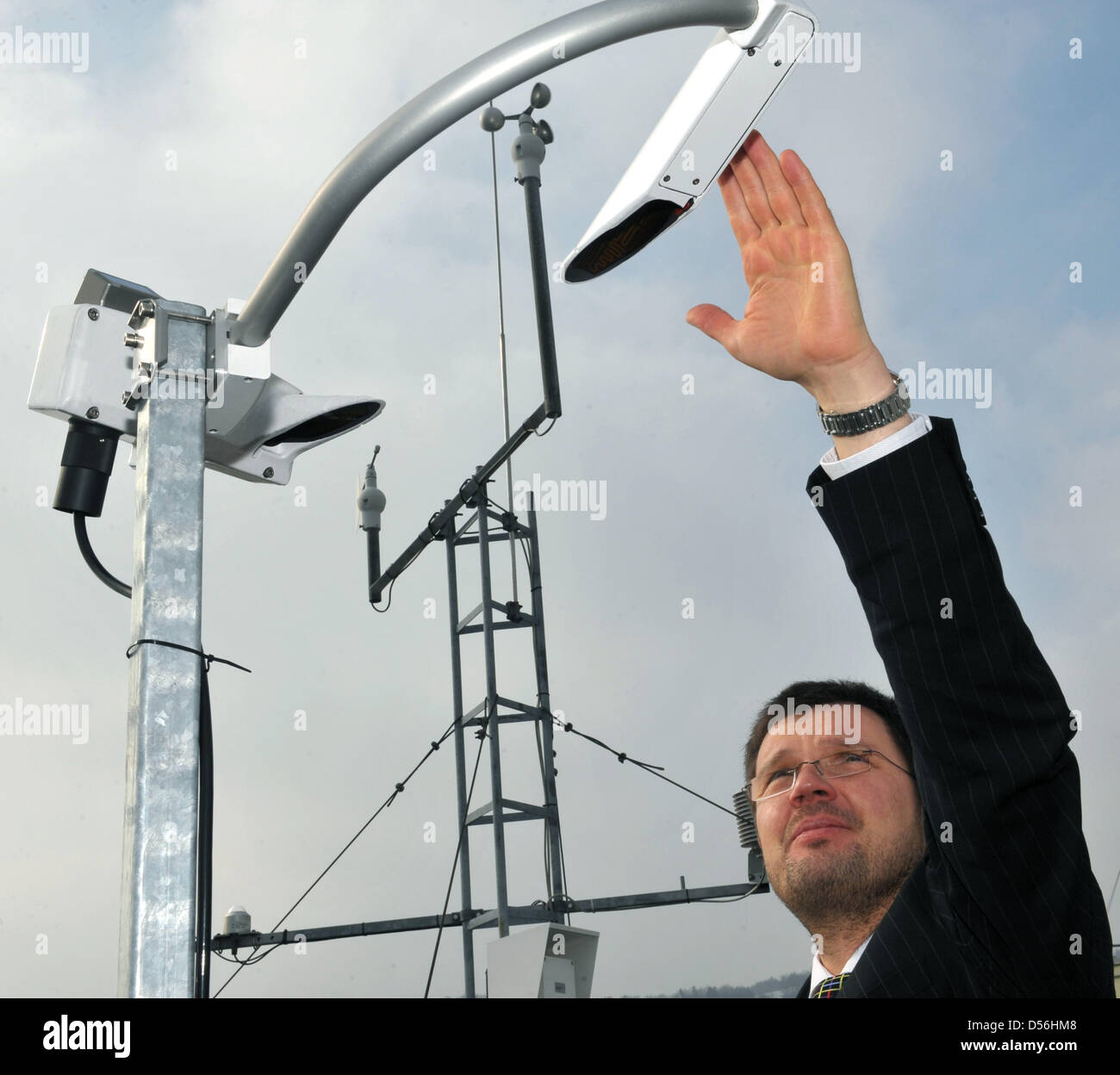 Prof. Dr. Michael Kaufmann of University of Apllied Sciences Jena poses with sensors for UV and solar radiation on the roof of climatologic gauging station in Jena, Germany, 11 March 2010. Since summer 1999 the station measures air temperature, relative humidity, precipitation, wind speed, air pressure and direction. Photo: Jan-Peter Kasper Stock Photo