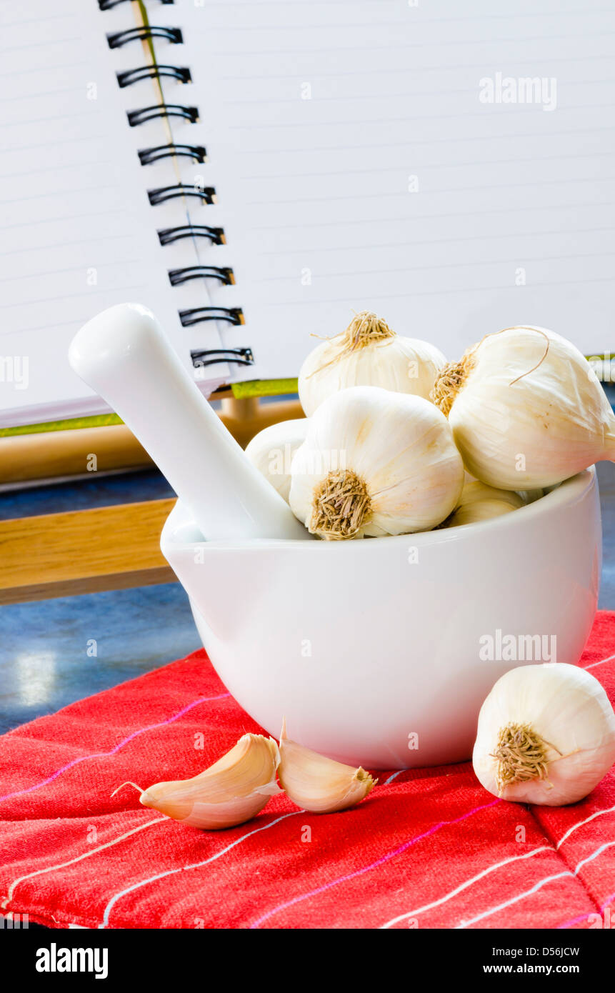 Garlic in a bowl in kitchen Stock Photo