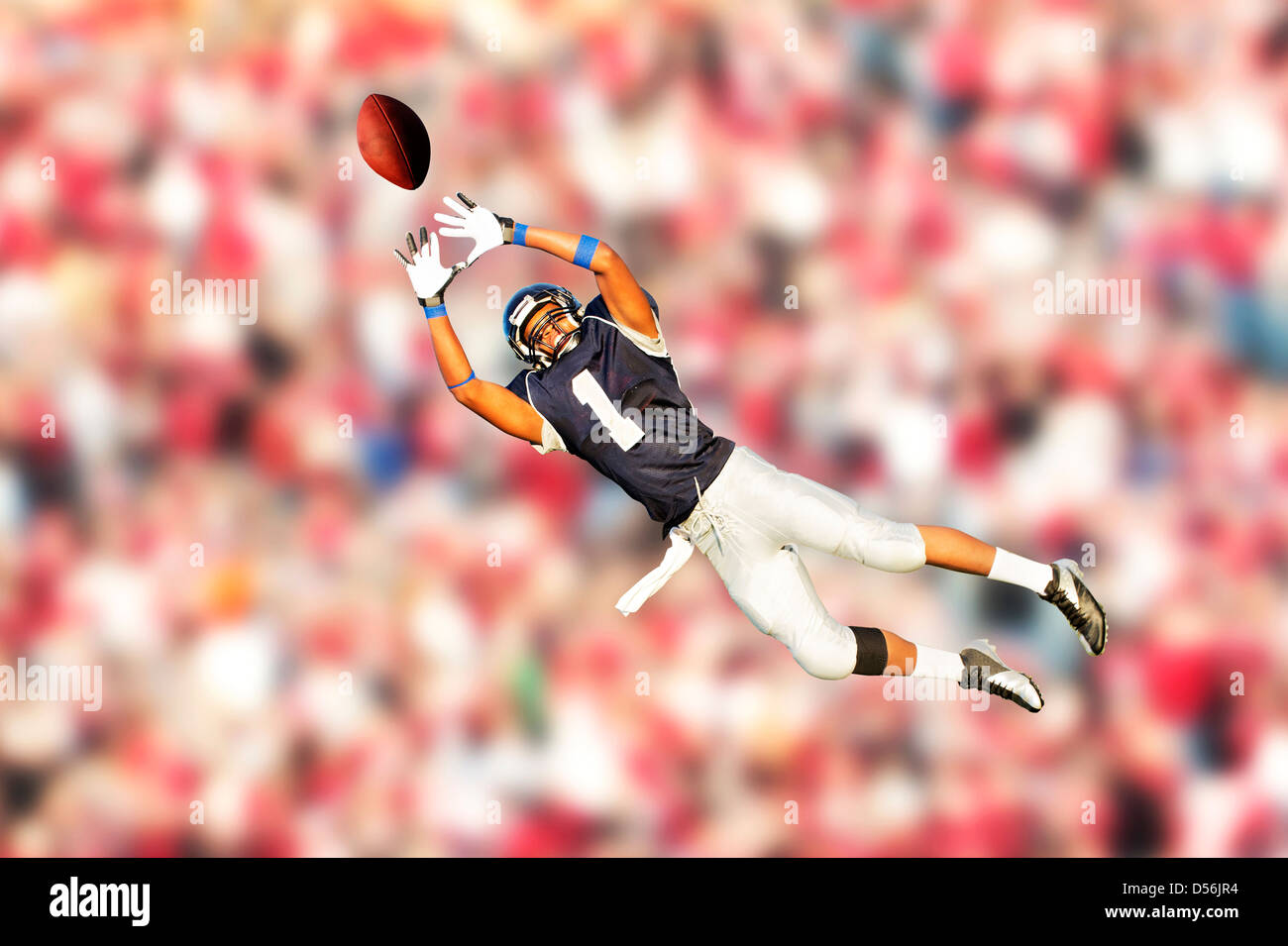 African American football player catching ball Stock Photo