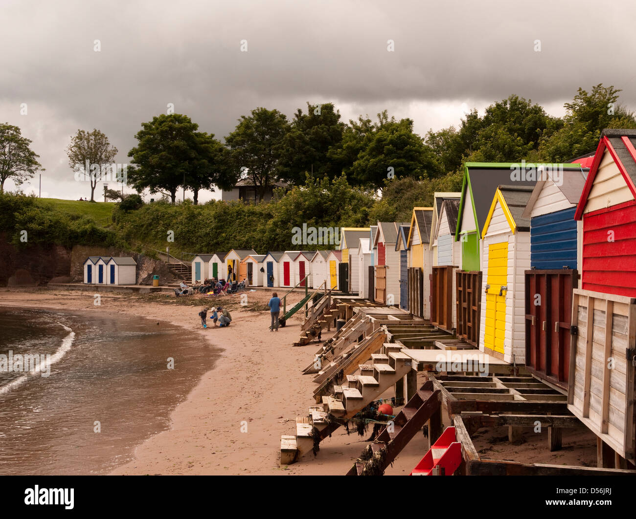 Colourful beach huts beside Corbyn Head, Torquay, Devon, England Stock Photo