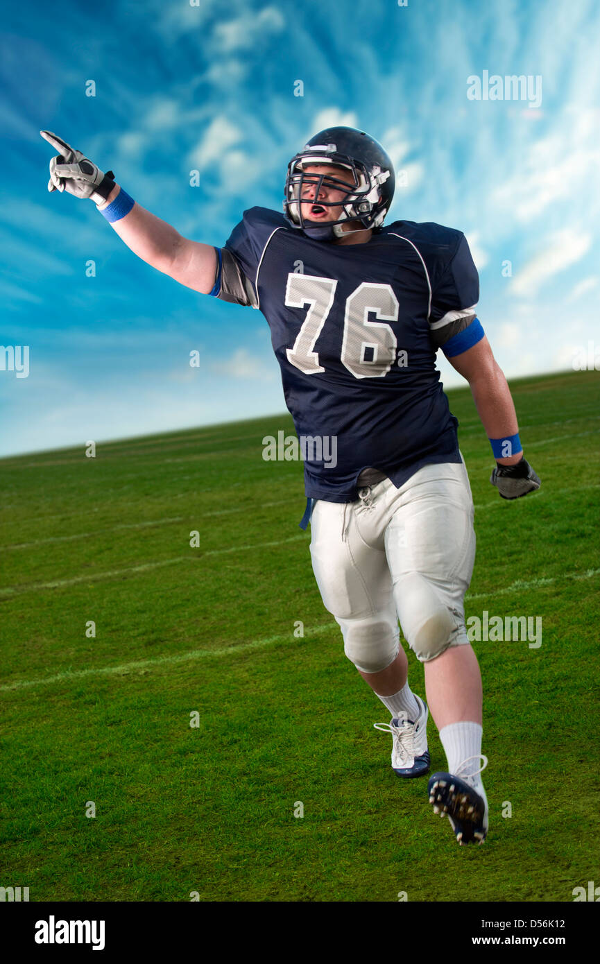 Caucasian football player cheering in game Stock Photo