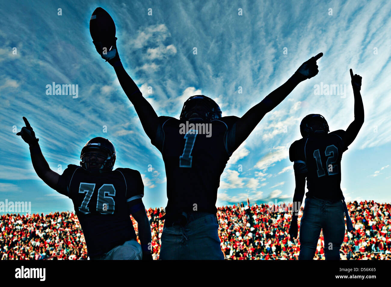 Football players cheering in game Stock Photo