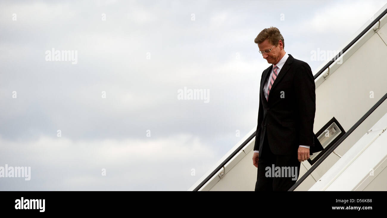 German Foreign Minister Guido Westerwelle leaves the plane and walks down the gangway at airport Tegel in Berlin, Germany, 13 March 2010. He returned from his so far longest foreign trip. Westerwelle has stood up upon his defense against the critic on his entrainment customs and talked about falsehood campaigns. Photo: ARNO BURGI Stock Photo