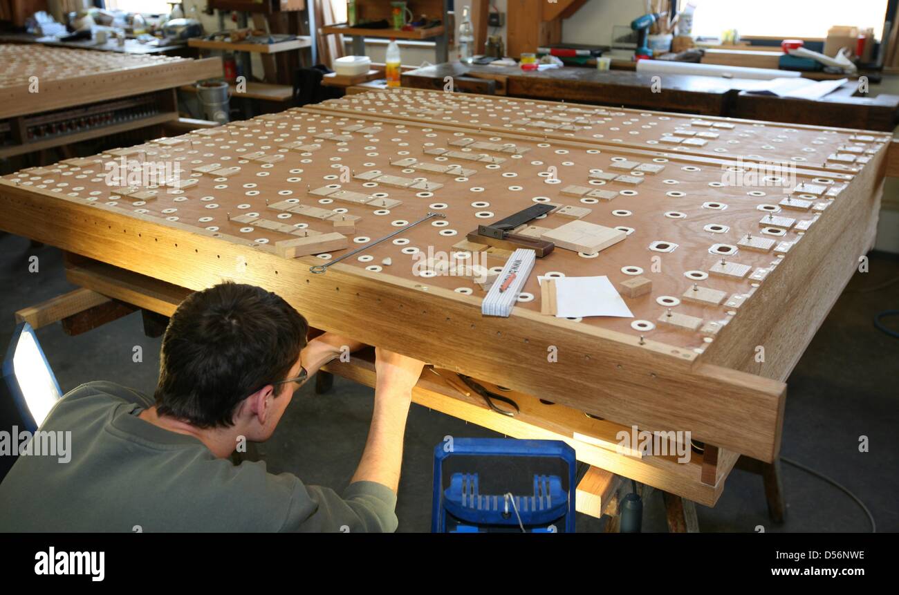 Organ builders of Schuke organ building company prepares pipes in