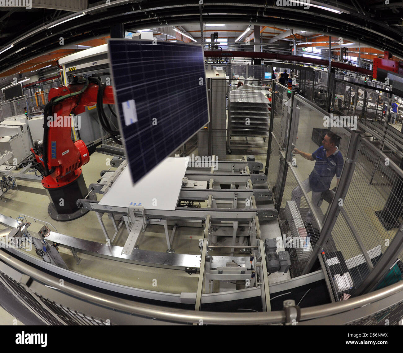 Two employees of aleo solar check a solar module after it was produced in Prenzlau, Germany, 11 March 2010. The 550 employees implement a production capacity of 180 megawatts. Established in 2001, aleo solat reported a tunrover of 376.1 million euro in 2009. Photo: Bernd Settnik Stock Photo