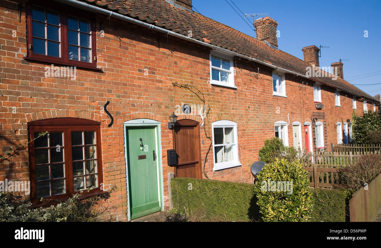 Row of small red brick traditional rural cottages, Long Row, Sudbourne, Suffolk, England Stock Photo