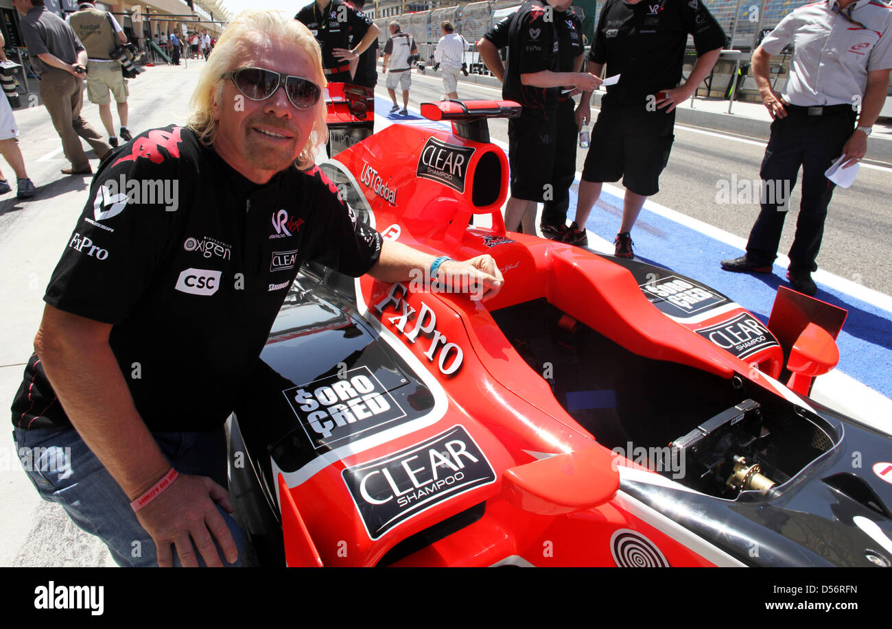 The boss of Virgin Group and owner of Virgin Racing, Richard Branson, poses next to one of his cars on the sidelines of the Grand Prix of Bahrain at the Sakhir race track, Bahrain, 14 March 2010. Photo: Jens Buettner Stock Photo