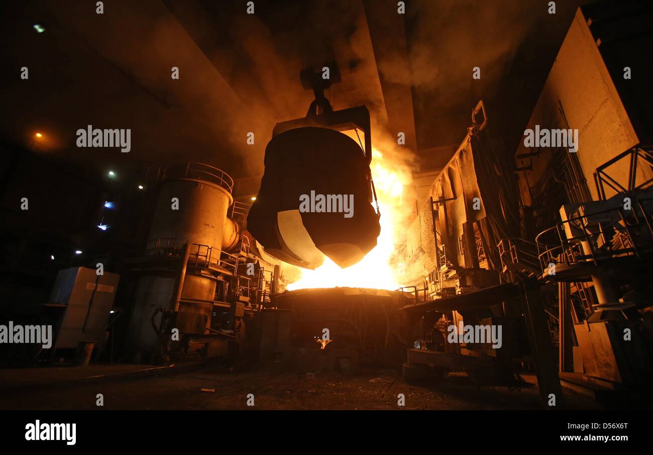 A container full of scrap metal is poured into an electric arc furnace