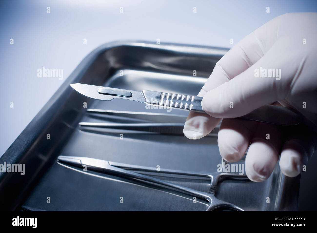 Close up of Hispanic doctor holding surgical equipment Stock Photo