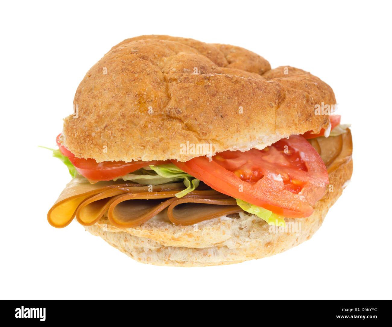 A tofu turkey sandwich with tomatoes and lettuce on a whole wheat bulky roll. Stock Photo