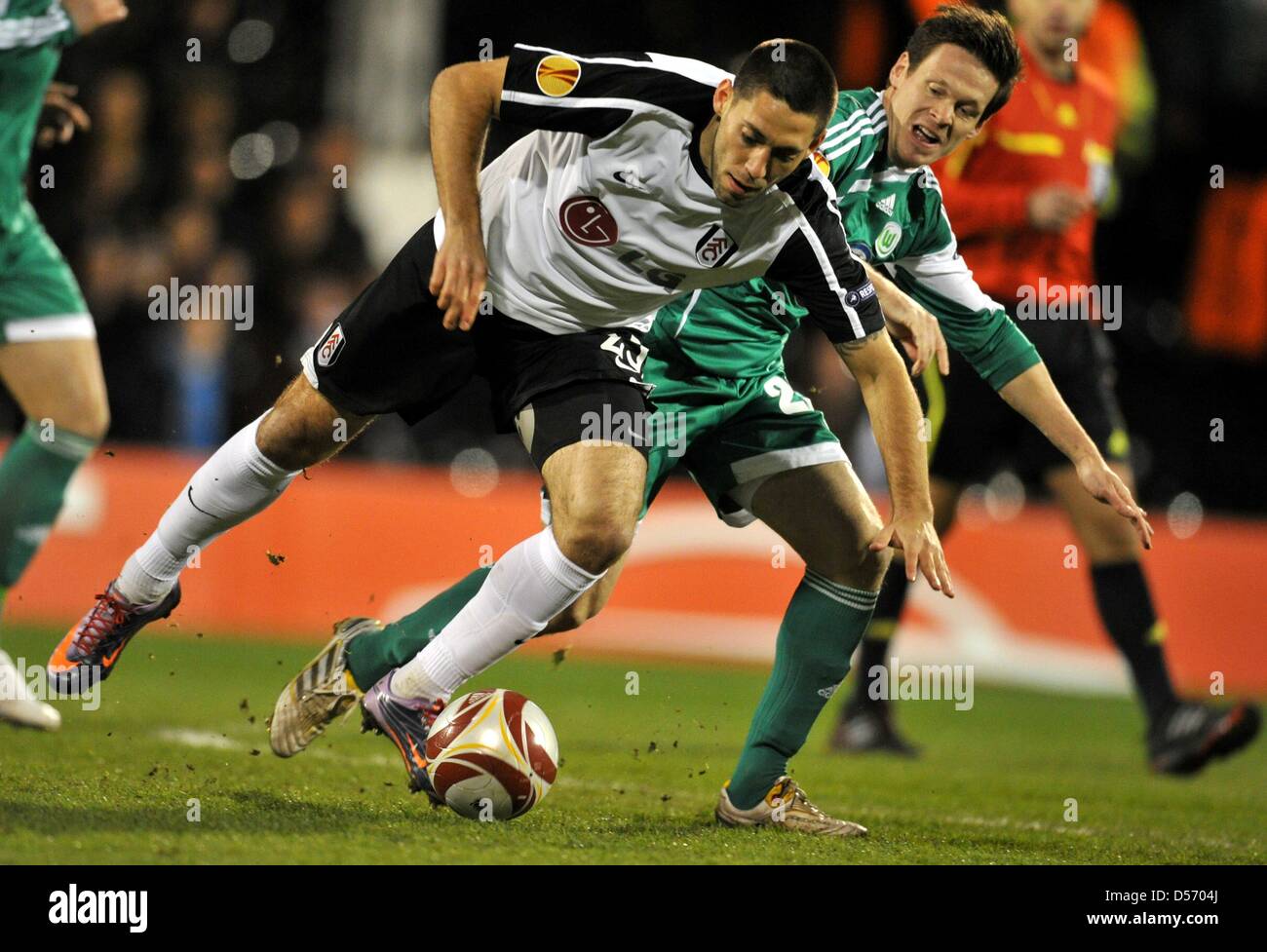 Fulham's Clint Dempsey (L) and Wolfsburg's Sascha Riether (R) vie for the ball during UEFA Europa League quarter-finals match FC Fulham vs VfL Wolfsburg at Craven Cottage stadium in London, Great Britain, 01 April 2010. Fulham won the first leg with 2-1. Photo: Jochen Luebke Stock Photo