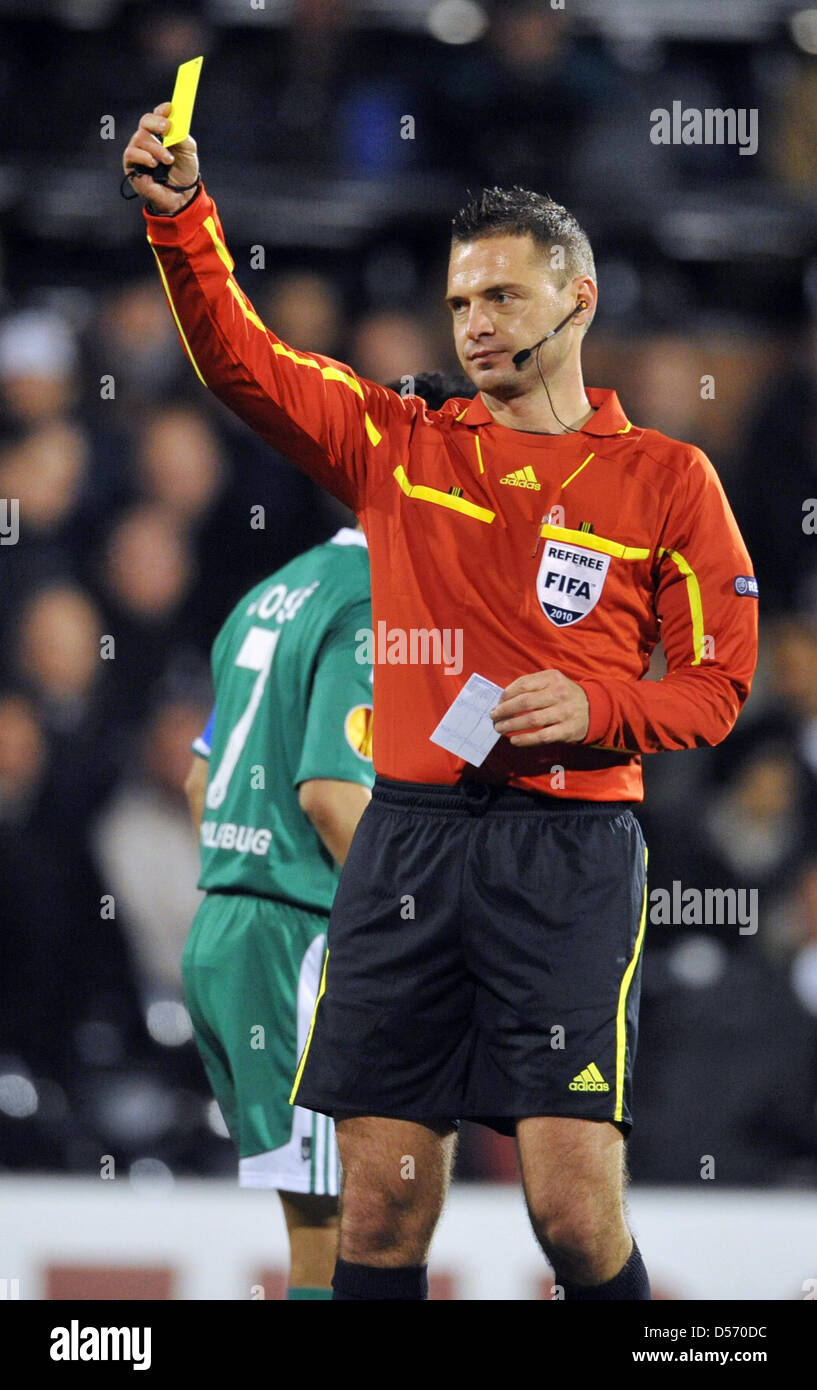 Referee Damir Skomina shows the yellow card during UEFA