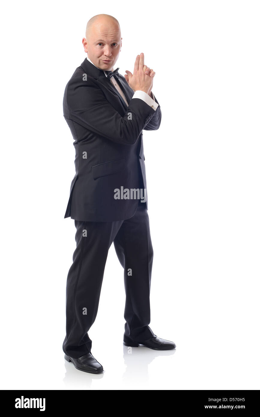 Man in tuxedo in a 007 james bond pose Stock Photo